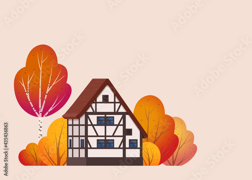 A beautiful half-timbered house is surrounded by bushes and trees