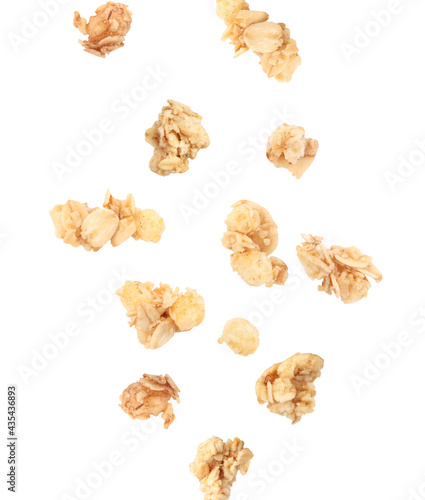 Delicious granola falling on white background. Healthy snack