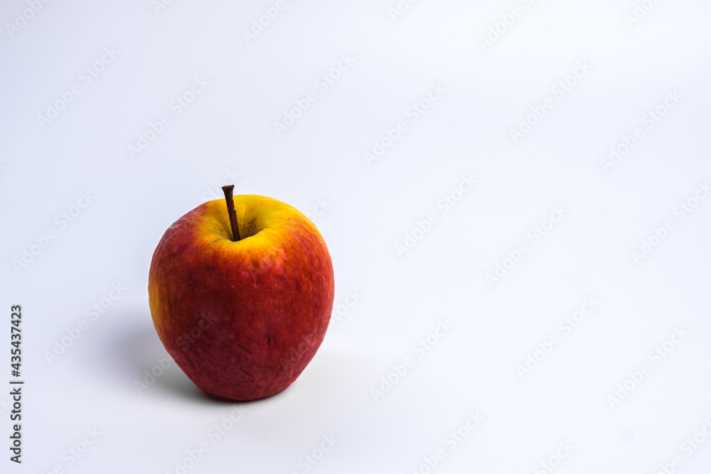 Isolated of white wallpaper of Spoiled red Apple with wrinkle surface that became yellow. Isolated of white wallpaper of Spoiled red Apple with wrinkle surface that became yellow.