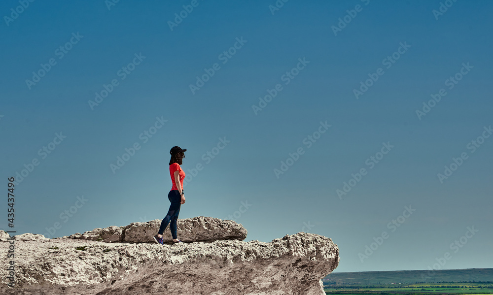 girl in sportswear at the top of the mountain