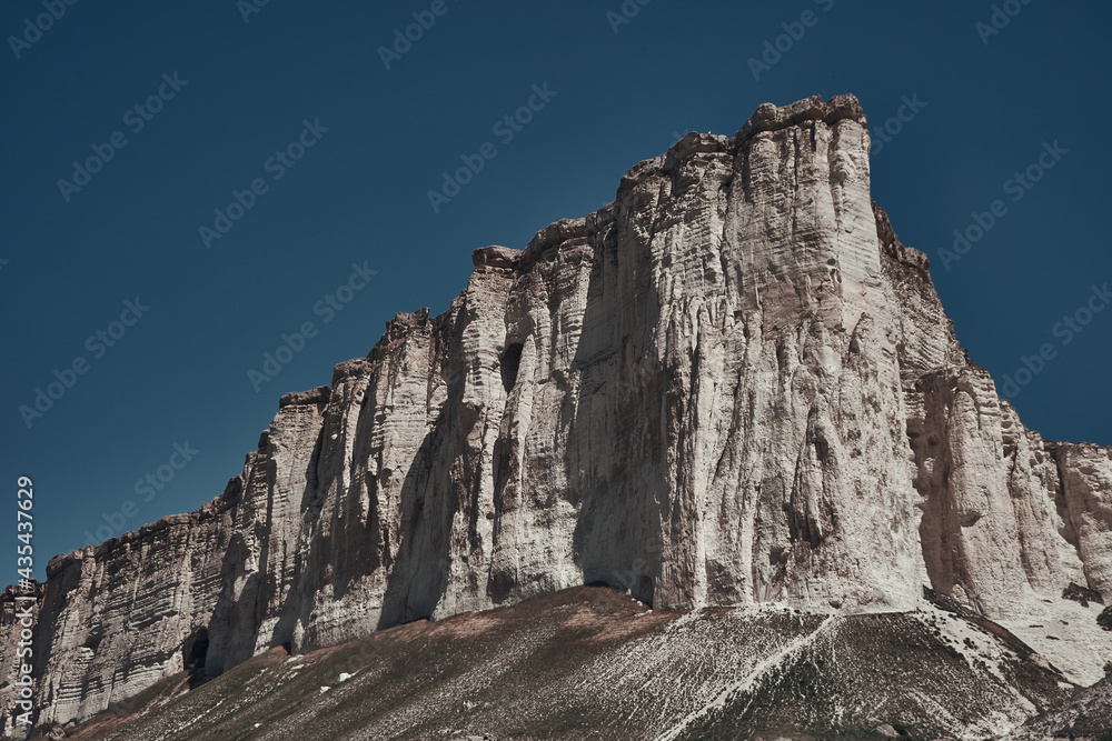 Fototapeta premium White rock mountain on a background of blue sky