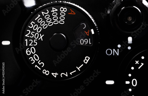 The close up of Speed shutter setting button on black retro camera with exposure setting and on-off switch button. 
It's easy to adjust setting quickly. photo