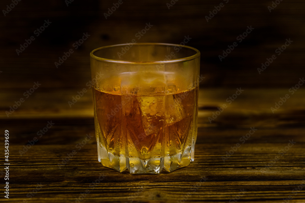Glass of whiskey on the dark wooden background Glass of whiskey on the dark wooden background