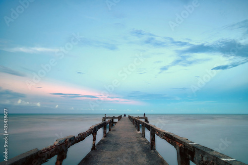 Seascape long exposure old fishing pier bridge at sunset, Chumphon Province, Southern Thailand, 