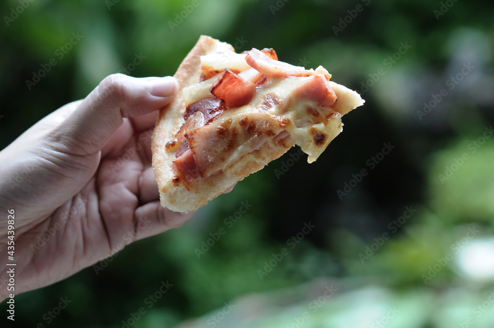 Pizza handle that looks delicious. Selective focus Pizza handle that looks delicious. Selective focus