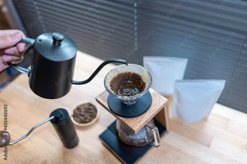Hand drip coffee, Barista making drip coffee with mockup blank package coffee Alternative ways of brewing Coffee shop concept Hand drip coffee, Barista making drip coffee with mockup blank package coffee Alternative ways of brewing Coffee shop concept