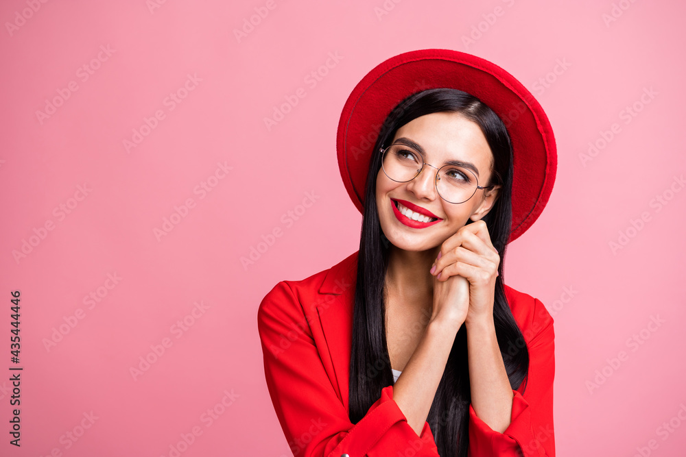 Photo portrait of dreamy girl looking at blank space resting head on two hands isolated on pastel pink colored background Photo portrait of dreamy girl looking at blank space resting head on two hands isolated on pastel pink colored background