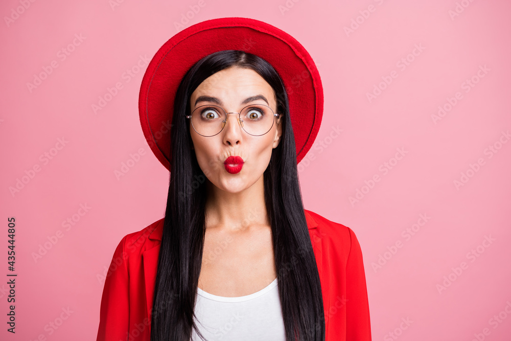 Fototapeta premium Photo portrait of flirty gorgeous woman sending air kiss isolated on pastel pink colored background