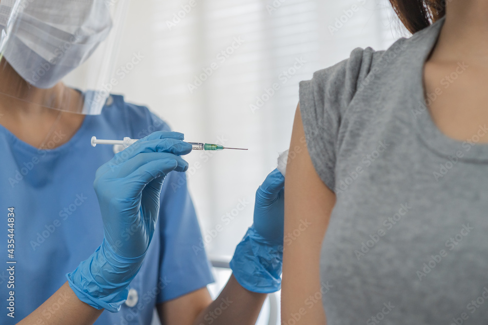 Covid-19,coronavirus hand of young woman nurse,doctor giving syringe vaccine, inject shot to asian arm's patient. Vaccination, immunization or disease prevention against flu or virus pandemic concept. Covid-19,coronavirus hand of young woman nurse,doctor giving syringe vaccine, inject shot to asian arm's patient. Vaccination, immunization or disease prevention against flu or virus pandemic concept.