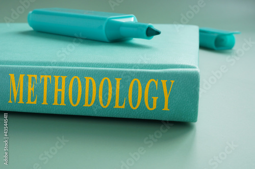 Book about methodology and marker on it. photo