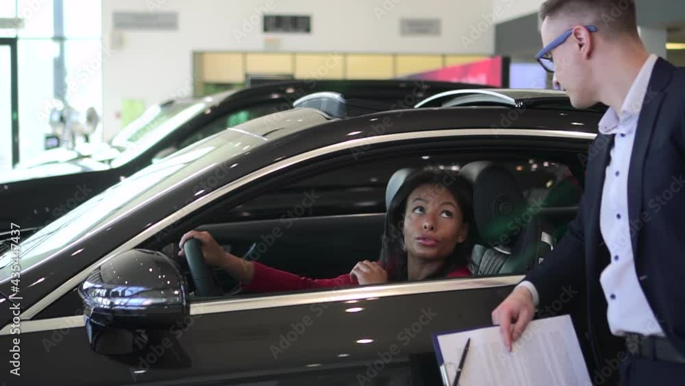 Sales manager car, woman sit in new auto and discuss purchase with agent Spbd. African 30s female Sales manager car, woman sit in new auto and discuss purchase with agent Spbd. African 30s female