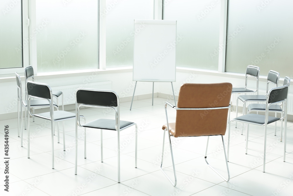 Flipchart and chairs in a bright office space Flipchart and chairs in a bright office space