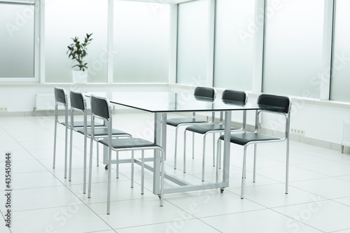 Black chairs and glass table in office space
