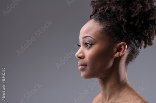 Profile portrait of a serious beautiful young black woman photo