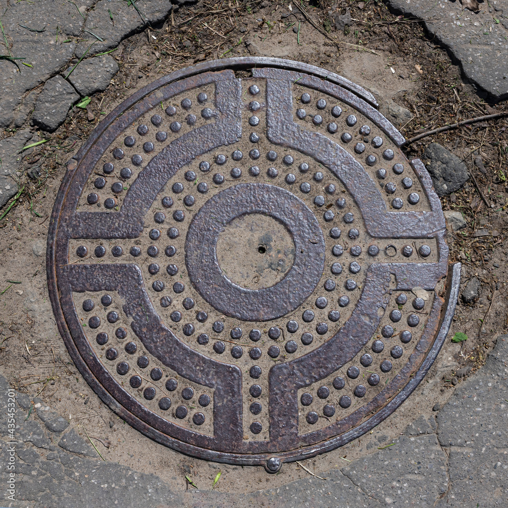 manhole cover on the pavement