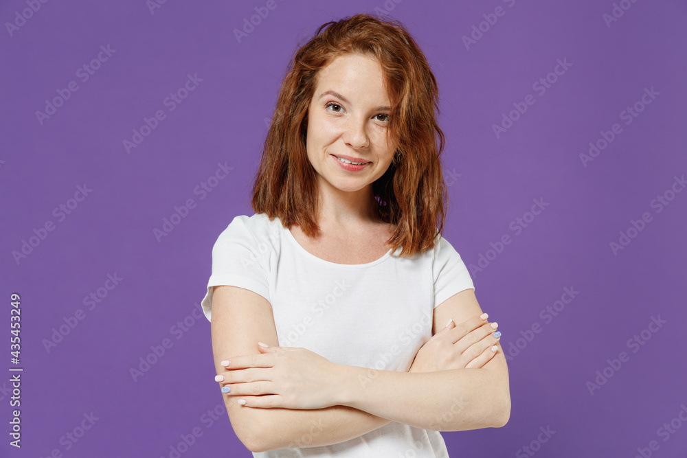 Young fun smiling happy friendly caucasian woman 20s wearing white basic t-shirt looking camera hold hands crossed folded isolated on dark violet background studio portrait. People lifestyle concept Young fun smiling happy friendly caucasian woman 20s wearing white basic t-shirt looking camera hold hands crossed folded isolated on dark violet background studio portrait. People lifestyle concept
