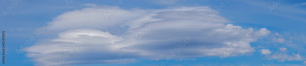 Blue sky with lenticular cloud formations, a rare natural phenomenon ...