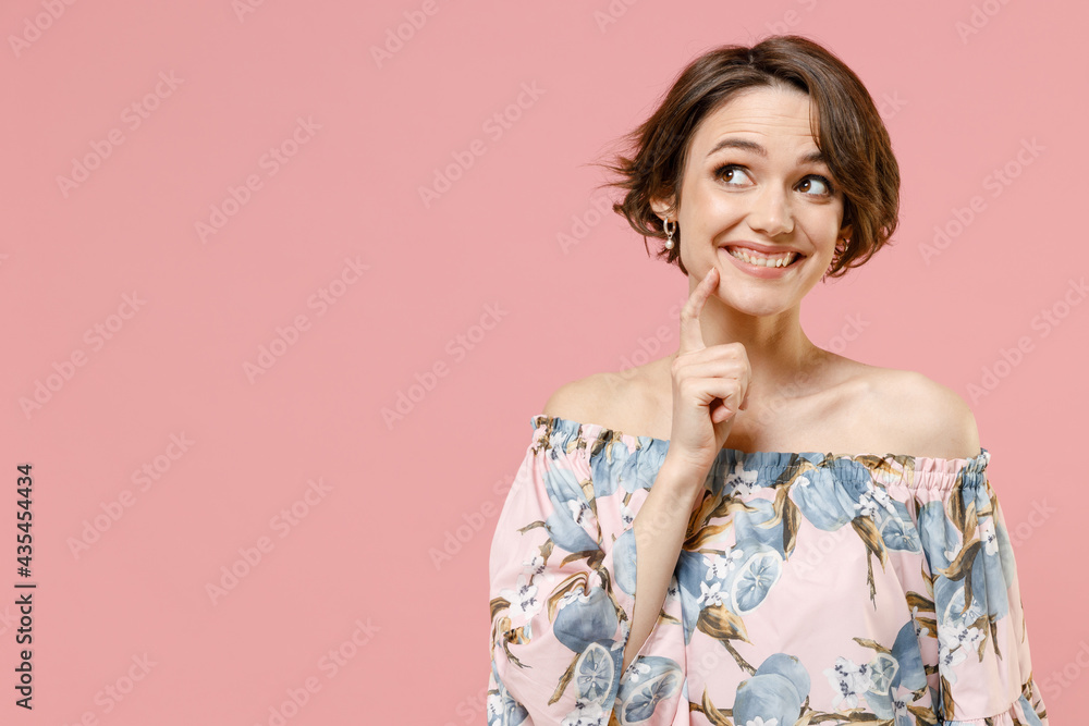 Young pensive dreamful thoughtful wistful caucasian woman 20s with short hairdo wear trendy blouse lok aside prop up chin isolated on pastel pink background studio portrait. People lifestyle concept. Young pensive dreamful thoughtful wistful caucasian woman 20s with short hairdo wear trendy blouse lok aside prop up chin isolated on pastel pink background studio portrait. People lifestyle concept.