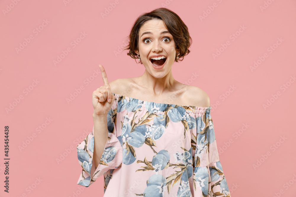 Young insighted smart proactive caucasian woman with short hairdo wear blouse holding index finger up with great new idea isolated on pastel pink background studio portrait. People lifestyle concept. Young insighted smart proactive caucasian woman with short hairdo wear blouse holding index finger up with great new idea isolated on pastel pink background studio portrait. People lifestyle concept.