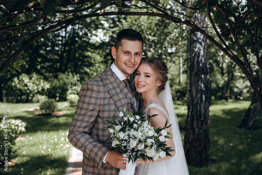 Walking the bride and groom outdoors. Beautiful summer photo session in nature. Walking the bride and groom outdoors. Beautiful summer photo session in nature.