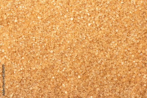 food background of yellow sanding sugar, full frame, top view