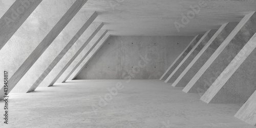 Abstract empty, modern concrete room with soft light from left with diagonal pillar walls and rough floor - industrial interior background template