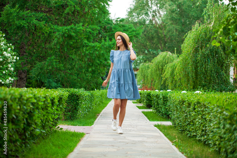 Brunette woman in a turquoise summer dress Brunette woman in a turquoise summer dress