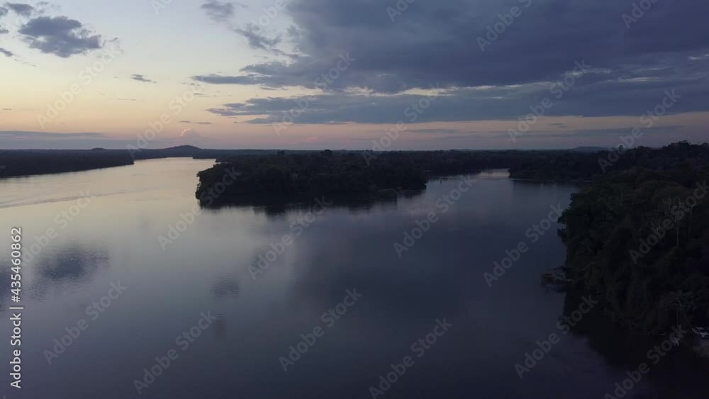 Beautiful Amazon rainforest landscape aerial view of boat sailing on the Juruena River and forest trees at dusk. Concept of biodiversity,transport, nature, environment, ecology. 4K Beautiful Amazon rainforest landscape aerial view of boat sailing on the Juruena River and forest trees at dusk. Concept of biodiversity,transport, nature, environment, ecology. 4K
