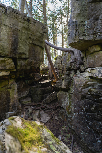 A narrow gap separates two large sections of limestone