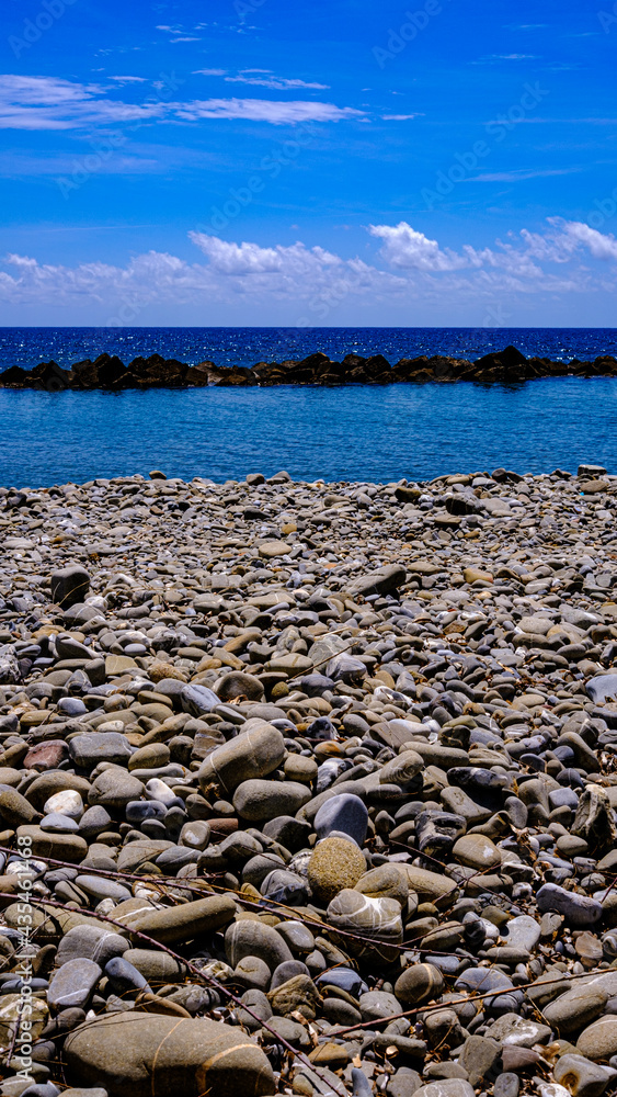 Pioppi beach, Cilento, Campania, Italy. Pebbles, blue sea and blue sky