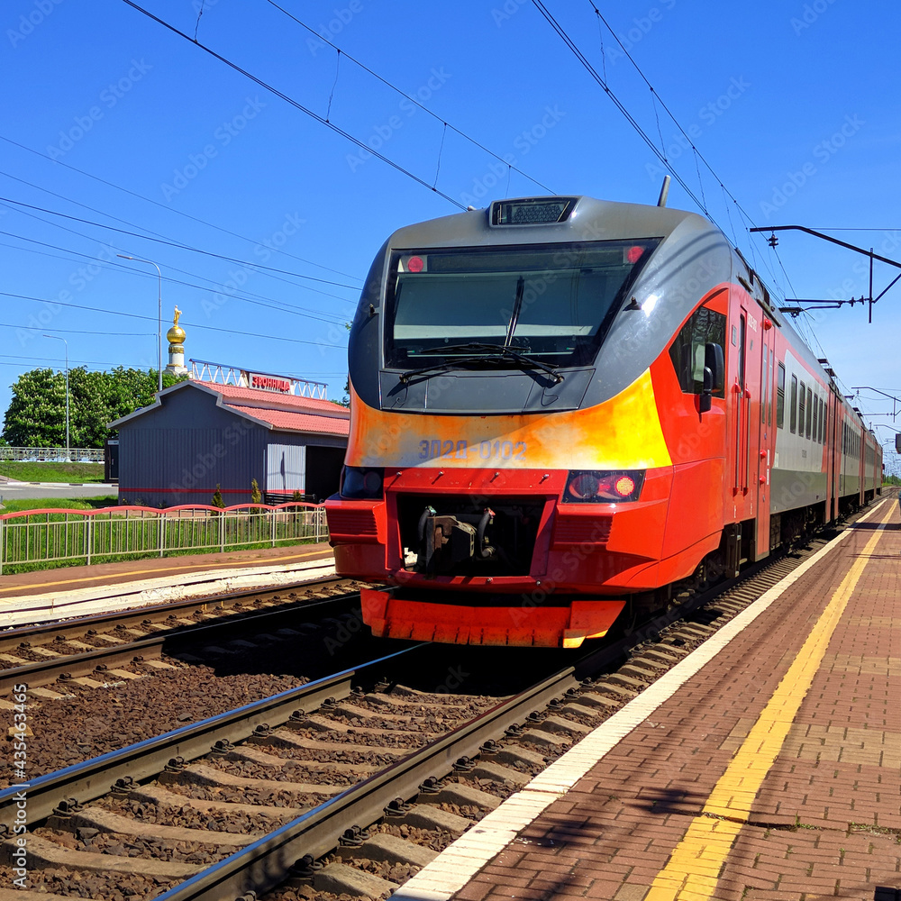 Red train at the stop belfry russia