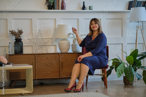 extravagant dressy lady at home. portrait of a confident mature woman. smiling woman looking at camera. Successful middle aged woman at home smiling.