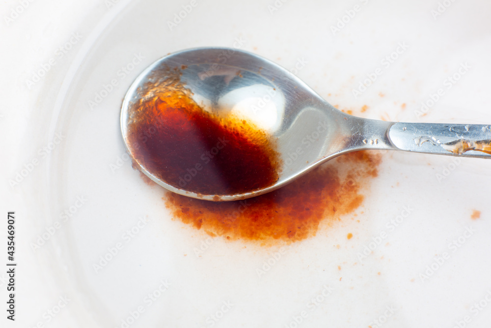 Spoon with Red abstract spot. Blood or jam stain with clots texture background. Spoon with Red abstract spot. Blood or jam stain with clots texture background.