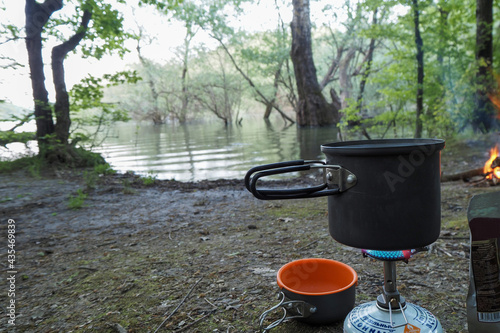 Boiling water in a pot on a burner on the bank of the Neberdzhaevsky reservoir