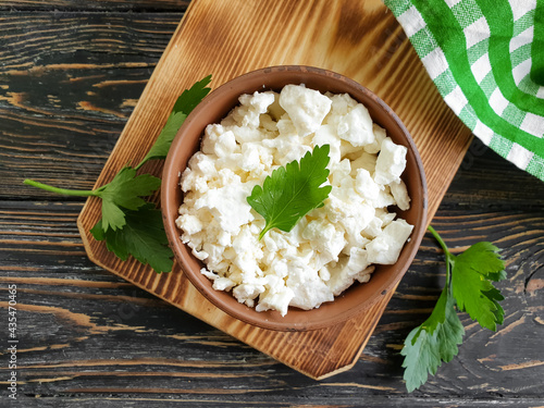 cottage cheese, parsley on a wooden background