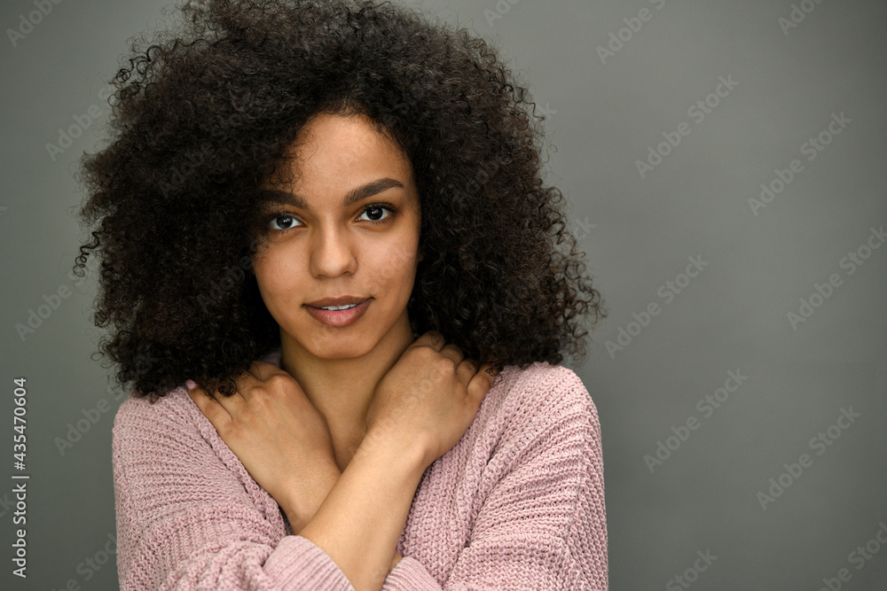 Studio portrait of a beautiful young African American woman with afro hairstyle. Studio portrait of a beautiful young African American woman with afro hairstyle.