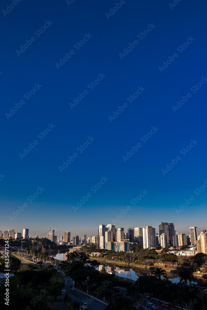 Fototapeta premium City skyline, with Marginal Avenue and Pinheiros River in the foreground, in the south zone of Sao Paulo, Brazil