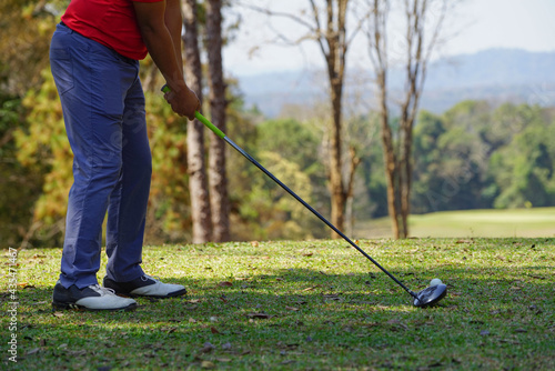 Golfer are playing game golf and hitting go on green grass mountain background. Asia male player game shot in summer. Sport holiday lifestyle concept.