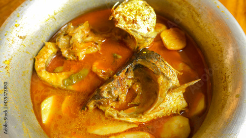 Homemade Cooked spicy Gravy Roho Labeo fish curry with potato South Asian style photo