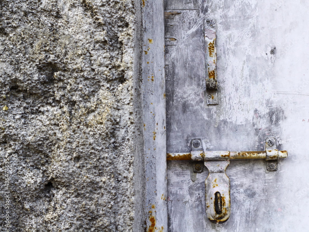 Ruined wall and old door rusty door latch Ruined wall and old door rusty door latch
