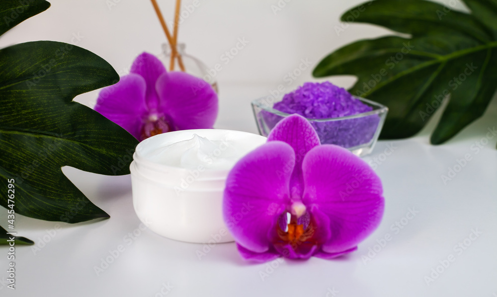 Spa treatments. Beauty and health concept. A jar of body cream and sea salt on white background. Close-up. Spa treatments. Beauty and health concept. A jar of body cream and sea salt on white background. Close-up.
