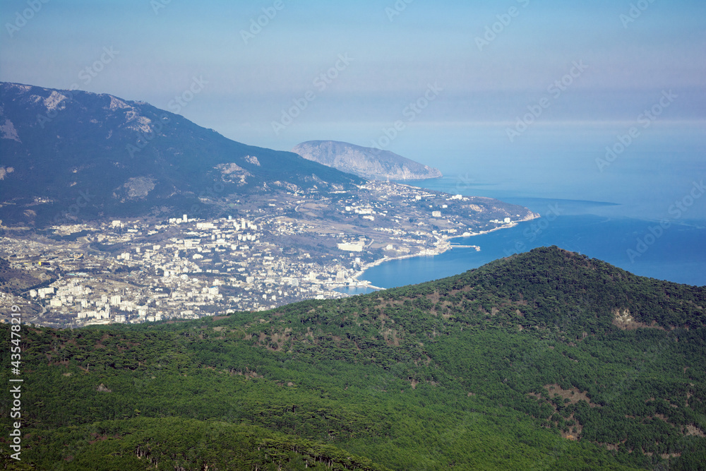 View of Yalta city, pine woods, Ayu-Dag mountain and Black sea from the top of Ai-Petri plato, Crimea, Yalta region