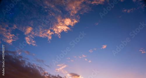 Beautiful golden hour clouds on a luminous blue sky during sunset