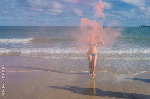 Portrait of young woman in bikini on tropical beach
