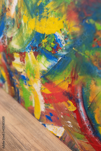 Colorful painted background texture at wooden table. Abstract oil painting