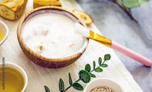 Homemade banana cosmetics. Cosmetic face mask with banana, oatmeal, honey, yolk. Natural skin care, wellness cosmetics,close-up. Diy banana mask,zero waste concept