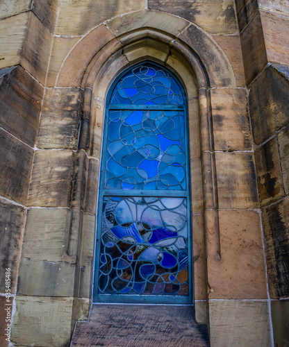 Beautiful Church window with reflectiv blue curvy patterns photo