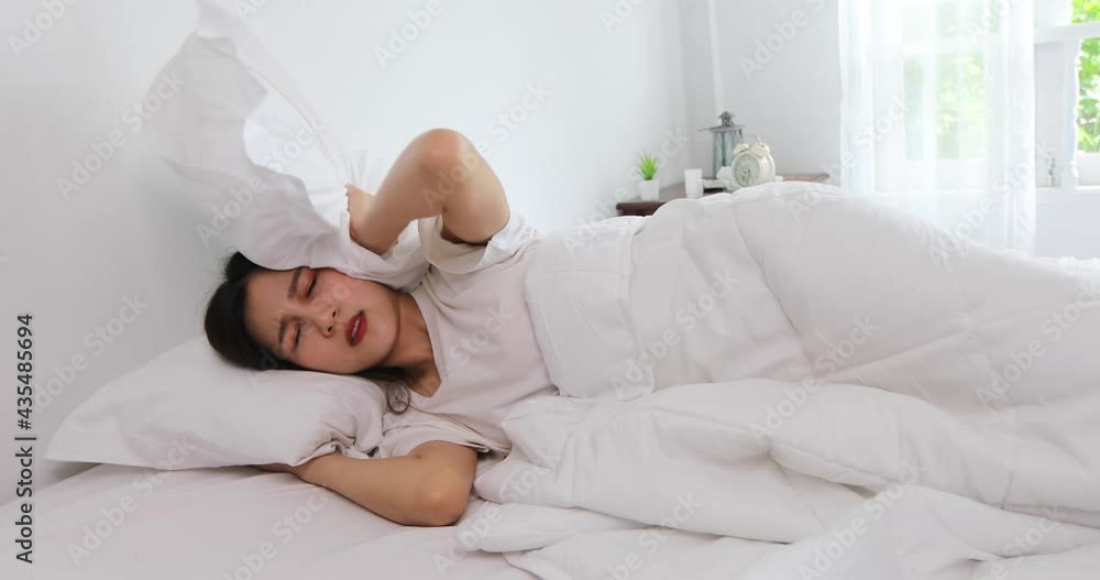 young beautiful Asian woman lying in bed late at night, struggling to sleep, suffers insomnia or fear of nightmares, looks sad, worried about mental health concepts young beautiful Asian woman lying in bed late at night, struggling to sleep, suffers insomnia or fear of nightmares, looks sad, worried about mental health concepts