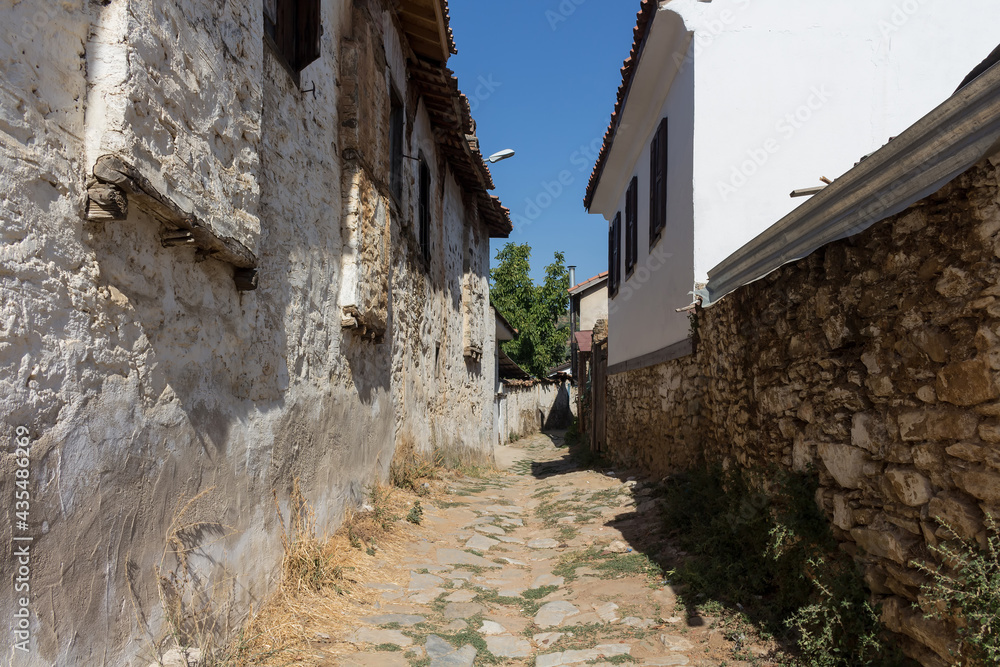 View of narrow street, old historical houses in famous, touristic Aegean mountain village called 