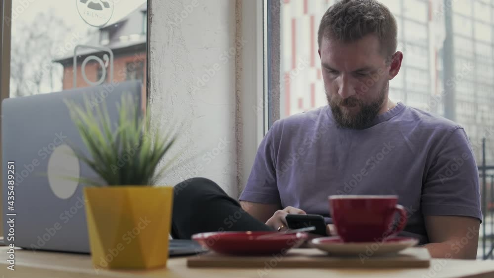 Bearded man surfing the phone Bearded man surfing the phone